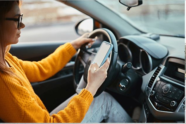 Woman driver looking at phone while driving